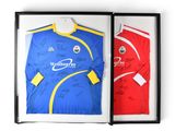 a framed picture of a soccer jersey and a signed shirt