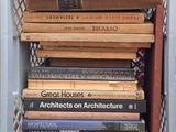 a stack of books sitting in a crate on top of a table