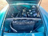 a blue car with an engine in the back of it