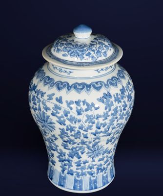 blue and white vase with a lid on a dark background