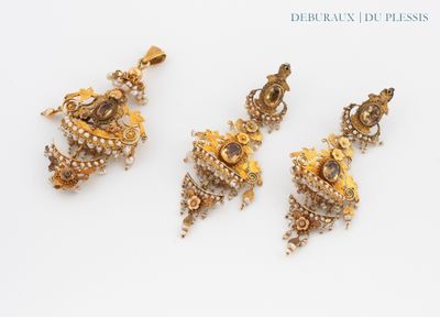 three pieces of gold and diamond jewelry on a white surface