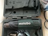 a corded drill in a case on the floor