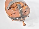 a small wooden musical instrument that is sitting on a white surface