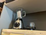 a blender sitting on top of a stove in a kitchen