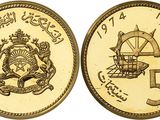 a close up of two gold coins with arabic writing on them
