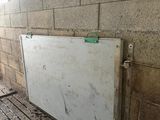 a white board sitting on the floor in a room