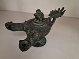 a bronze statue of a bird with a bird on it ' s back