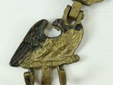 a bird shaped keychain hanging from a metal hook