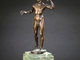 une image représentant une statue en bronze d'un homme posée sur un socle en marbre