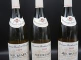 trois bouteilles de vin posées sur une table l'une à côté de l'autre