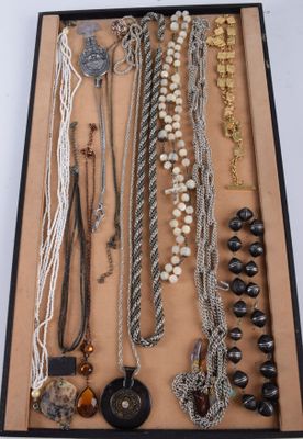 many different necklaces and bracelets displayed in a box