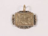 a small gold pendant with a picture of a man on it