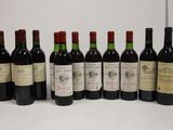 several bottles of wine are lined up on a table