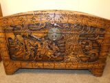 a wooden chest with carvings on it in a room