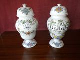 two vases that have been decorated with flowers on them