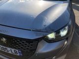 a car that has been damaged and is parked on the side of the road