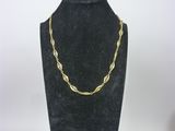 a black mannequin with a gold chain on it