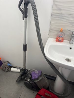 a small bathroom with a sink and a vacuum in it