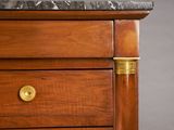 a close up of a wooden dresser with a marble top