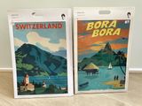 two posters of switzerland and bora bora are displayed on the floor