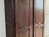 an old wooden armoire sitting on top of a hard wood floor