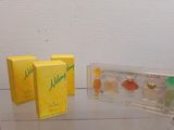 three boxes of perfume sitting on a glass table
