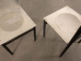 two chairs that have holes in the back of them