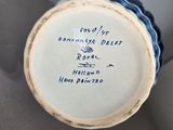 a blue and white vase with writing on it