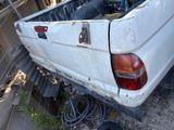 a white truck that is parked next to a fence