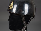 an old helmet with a gold star on it on a black mannequin head
