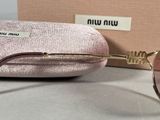 blond woman ' s sunglasses in a pink case and a pair of pink sunglasses