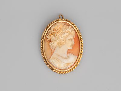 a gold - plated cameo of a woman wearing a pearl necklace