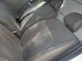 the back seats of a car are covered in gray cloth