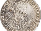 a close up of a silver coin with a crown on it