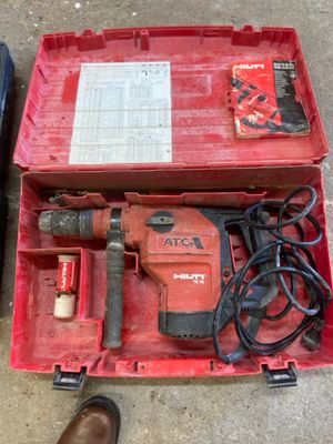 a red tool box with tools in it on the ground