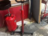 a red fire extinguisor sitting next to a stack of wood