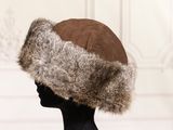 a woman wearing a hat with fur on top of her head