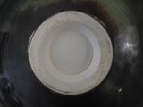 a close up of a black and white vase with a white lid