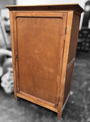 a small wooden cabinet with a door on top of it