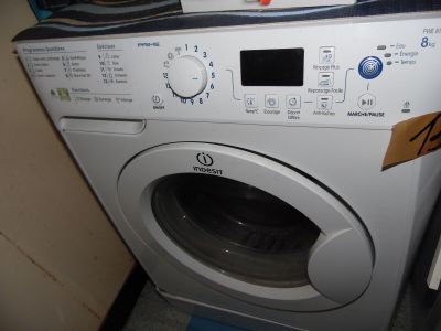 a washing machine with a button on the front of it