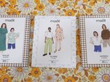 three sewing patterns of women ' s clothing on a yellow floral background