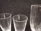 three wine glasses sitting next to each other on a table