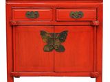 an image of a red cabinet with two drawers and a butterfly on it