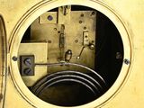 a clock that is sitting inside of a metal box