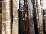many rolls of fabric sitting on the floor in a warehouse