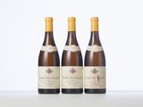 three bottles of wine sitting on top of a white table