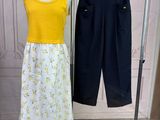 yellow top and black pants on a mannequin stand