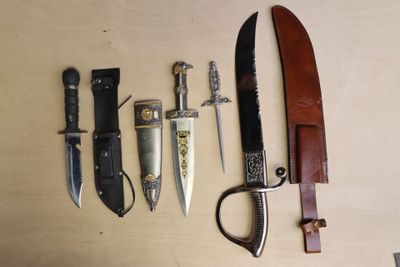several different types of knives are lined up on a table