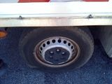a close up of a flat tire on a flatbed truck