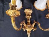 two lamps that are on the wall next to each other